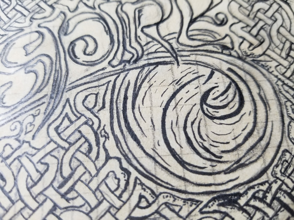 Close up detail of the drawing phase of the Inspire painting showing the underlying grid and the water swoosh at the end of the word